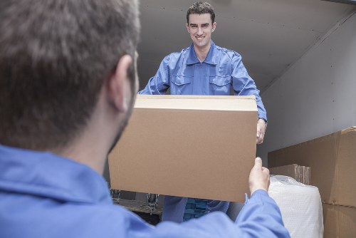 Flat removals in Newmalden with professional movers loading apartment furniture